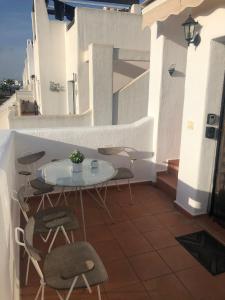 a patio with a table and chairs on a balcony at "La Piña" Condado Golfresort 1574 in Alhama de Murcia