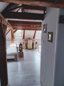 a room with a bed and a room with tables at Pension Novy Den in Albrechtice