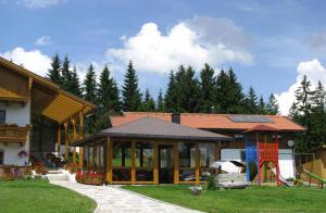 a house with a pavilion in a yard with trees at Haus Spannbauer in Neureichenau