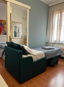 a bedroom with a bed and a couch at Al teatro in Padova