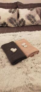 a brown blanket with two hearts on a bed at Apartament Sosnowiec - Kazimierz Górniczy in Sosnowiec