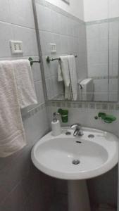 a bathroom with a sink and a mirror and towels at Bed and Breakfast Baobab in Piazza Armerina