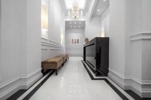 a lobby with a couch and a chandelier at Praxitelous Luxury Suites in Athens