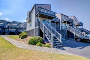 a apartment building with stairs and a parking lot at Shipwatch Villas in North Topsail Beach