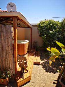 a gazebo with a hot tub on a patio at Bona Lodge in Cape Town