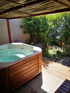 a jacuzzi tub sitting on a patio at Bona Lodge in Cape Town