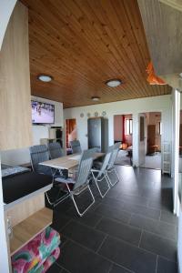 a dining room and living room with a table and chairs at Nefelejcs in Zamárdi