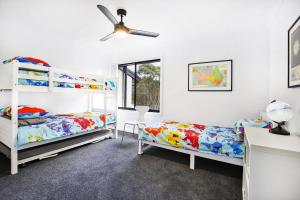 a bedroom with two beds and a ceiling fan at Zen @ Culburra - Pet Friendly - 8 Mins to Beach in Culburra Beach