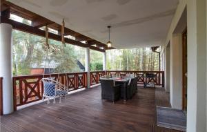 a porch with a table and chairs on a deck at 3 Bedroom Awesome Home In Ryn in Ryn