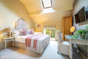 En eller flere senge i et værelse på Gardeners Cottage