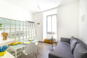 a living room with a couch and a table at Hostly - Nicole Apartment Volturno- Full Rome Center in Rome
