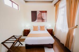 a bedroom with a bed and a window at Hotel Palace Galapagos in Puerto Ayora