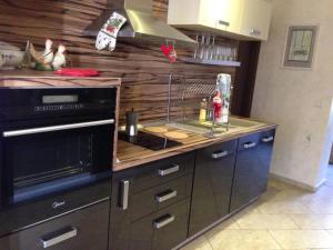 a kitchen with a stove and a counter top at The Lake Villa in Smolyan