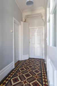 a hallway with a door and a tile floor at Handpost Retreat in Newport