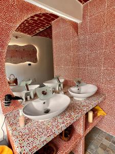 a bathroom with two sinks and a mirror at Dormi nella SPA privata con letto ad acqua, sauna, doccia emozionale e kneipp in Alessandria