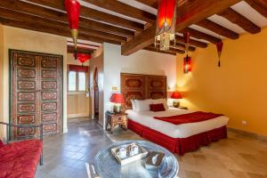 a bedroom with a bed and a table in a room at Le Clos Des Fontaines in Jumièges