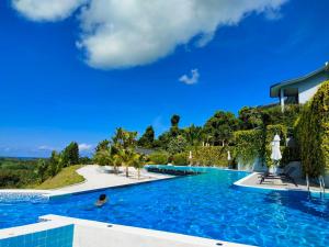 a large swimming pool with a blue sky in the background at Khaolak Blue Sky Villa in Khao Lak
