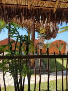 a straw hut with some plants in the grass at Pousada Kite Guajiru in Itarema +72 photos