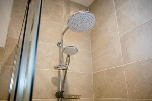 a shower with a shower head in a bathroom at Burnside Cottage, Wark, Hexham in Hexham +22 photos