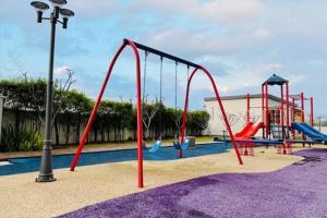 a playground with a slide and swings at New Condo SYMPHONY II in Kajang , Semenyih in Semenyih