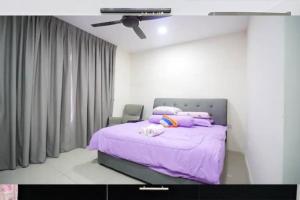 a bedroom with a purple bed with a ceiling fan at New Condo SYMPHONY II in Kajang , Semenyih in Semenyih