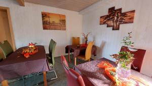 a dining room with two tables and chairs at Pension Haus Germania in Erfurt