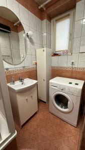 a bathroom with a washing machine and a sink at Pokoje w Gołdapi in Gołdap