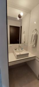 a bathroom with a sink and a large mirror at Apart Plaza in San Salvador de Jujuy