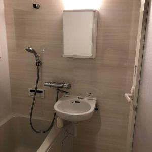 a bathroom with a sink and a shower with a mirror at 京美 in Anju +9 photos