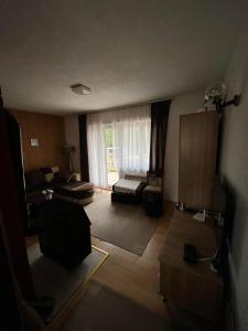 a living room with a couch and a window at Kuća Janjic Jahorina in Jahorina