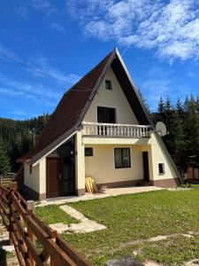 a small white house with a brown roof at Kuća Janjic Jahorina in Jahorina