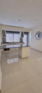 a large white kitchen with a sink and a counter at Byblos Prime in Aqaba