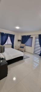 a bedroom with a large bed and blue curtains at Byblos Prime in Aqaba