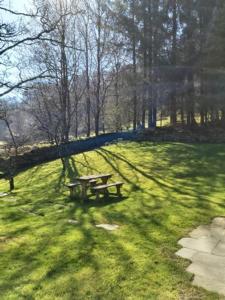 a picnic table sitting in the grass in a park at Longhouse - Y Beudy in Rhayader