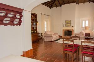 a living room with a table and a fireplace at Hotel Rural Monte da Provença in Elvas