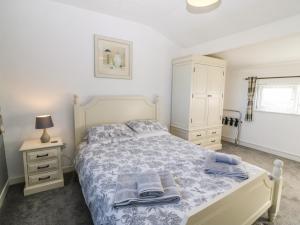 a bedroom with a bed and a dresser with towels on it at Beach Reach in Valley