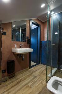 a bathroom with a sink and a glass shower at Apart Hotel GOLDEN apartments in Košice