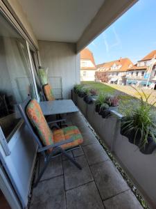 a patio with a table and chairs and potted plants at Business Apartment in Rheinfelden(Baden) in Rheinfelden