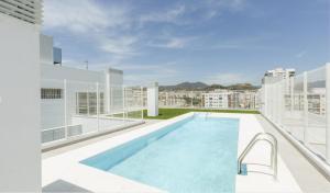 a swimming pool on the roof of a building at Fabuloso Apartamento nuevo con Parking y Piscina in Málaga