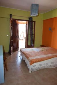 a bedroom with a large bed in a room at Villa EnElladi in Neos Pirgos