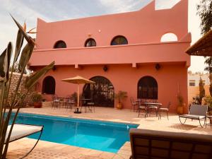 a house with a swimming pool in front of it at Villa nouran in Ghazoua