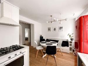 a kitchen with a table and chairs in a room at Apartament Kętrzyn in Kętrzyn