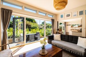a living room with a couch and a large window at Chi Lowarth in Helston