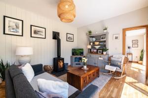 a living room with a couch and a wood stove at Chi Lowarth in Helston
