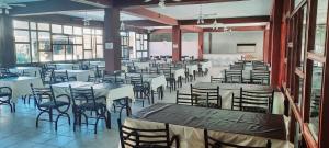 a large room with tables and chairs and windows at Hotel Mar Del Plata in Termas de Río Hondo +14 photos