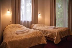 Säng eller sängar i ett rum på Modlin Palace