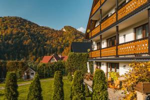 a building with a bunch of trees in front of it at Willa Aurinia in Szczawnica