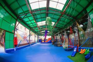 an indoor playground with a slide and swings at Hotel Bourbon Ibirapuera Suite 5 estrelas Moema in São Paulo