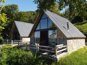 a cabin with glass doors and a roof at ONASUITBUNGALOW in Rize