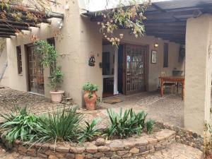 an outside view of a house with a table and a patio at Aurora Bushbaby 1 in Centurion